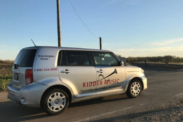Kidder Music Vehicle Driving Down the Road